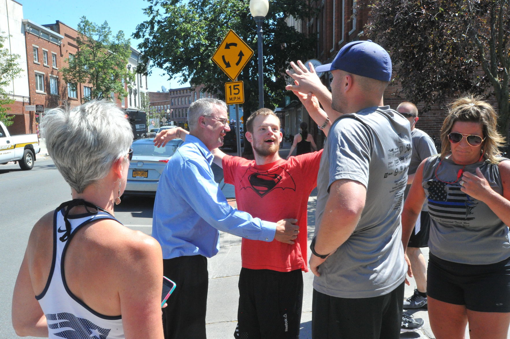 Maxwell high-fives runners at finish